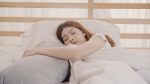 Asian woman dreaming while sleeping on bed in bedroom, Beautiful japanese female using relax time lying on bed at home. Lifestyle women using relax time at home concept.